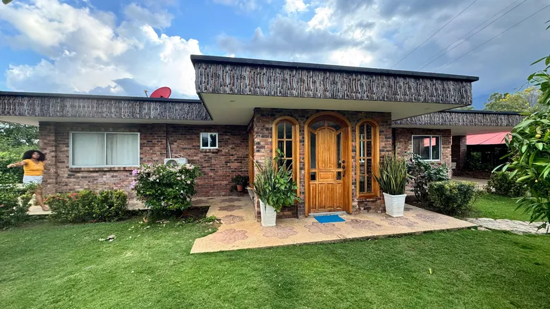 Well-maintained brick house with garden pathway plants and lush green front yard in Melbourne